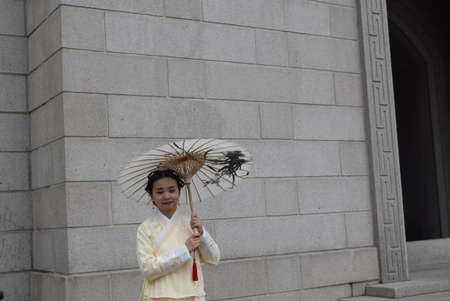 Unidentified woman in traditional clothes at the Tokyo Imperial Palace in Tokyo, Japan.の写真素材