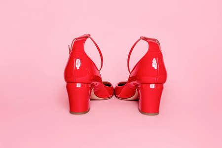 Fashionable red patent leather shoes on a pink background. Frontal viewの写真素材