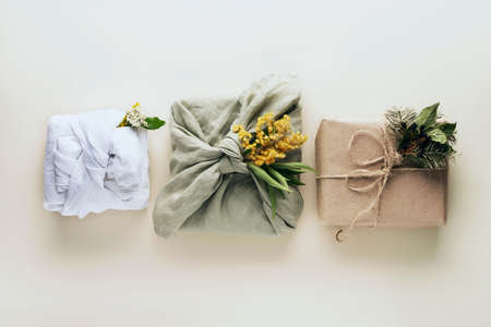 Eco Christmas gift three boxes. Top view. On a beige background.