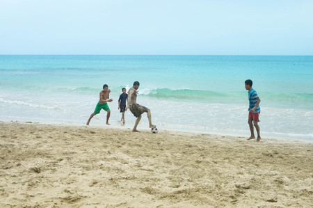 Great Corn Island, Nicaragua - July 10, 2015:  Local teens play football on the beach by the Caribbean in Great Corn Island, Nicaraguaのeditorial素材