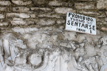 Close up of the stone carvings at Tonina archaeological site in Ocosingo, Chiapas, Mexico. The sign in Spanish says âit is prohibited to sit on the throneâのeditorial素材
