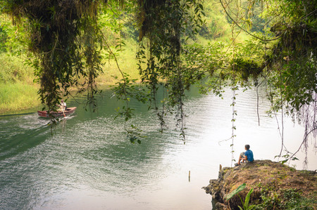 Honduran boy is looking down from the cliff in Los Naranjos national park, Honduras. Central Americaのeditorial素材