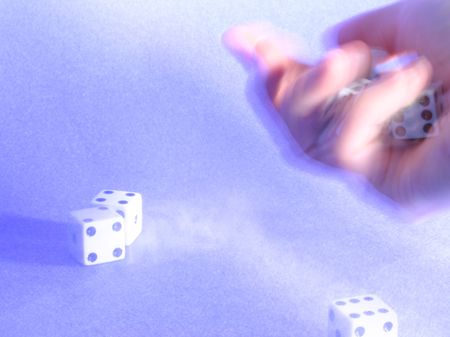 hand shaking dices over texturized blue backgroundの写真素材