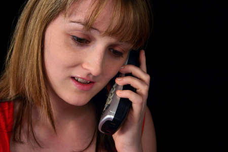 Portrait of a nice looking young woman with telephoneの写真素材