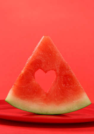 sliced water-melon with heart holeの写真素材