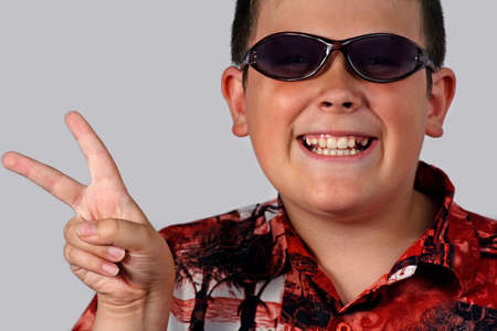 young boy with a cool attitude with sunglassesの写真素材