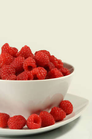 bunch of fresh raspberries on white bowl