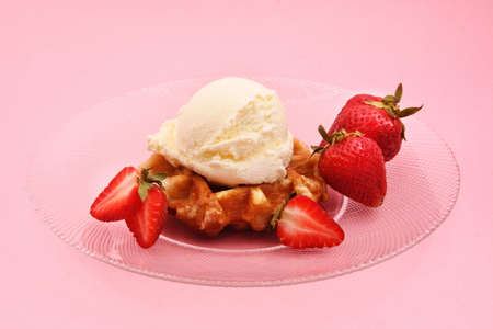 Belgian waffles with strawberries and ice creamの写真素材