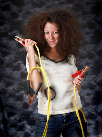 theatrical image of woman with booster cableの写真素材