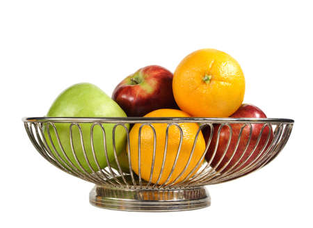 some fresh fruit in metallic basket, isolated on whiteの写真素材