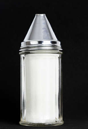 tranparent sugar container with metallic cover, black backgroundの写真素材