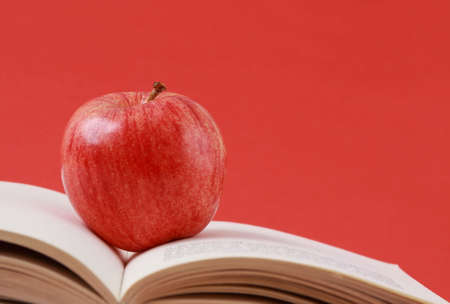 apple and book, red backgroundの写真素材