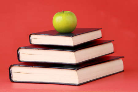 green apple and book, red backgroundの写真素材