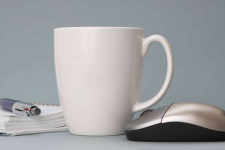cup of coffee with agenda and computer mouseの写真素材
