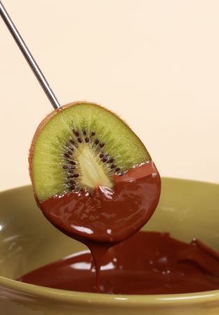 chocolate fondue kit and fresh fruit, beige backgroundの写真素材