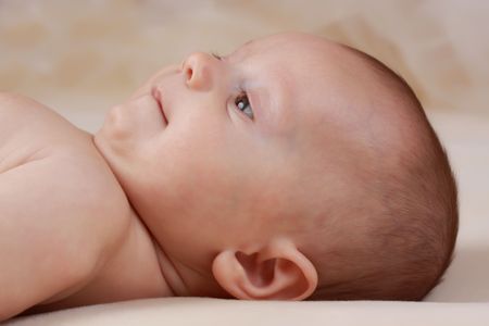 portrait of a cute caucasian baby girl, beige background