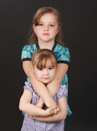 cute caucasian little blond girl, black backgroundの写真素材