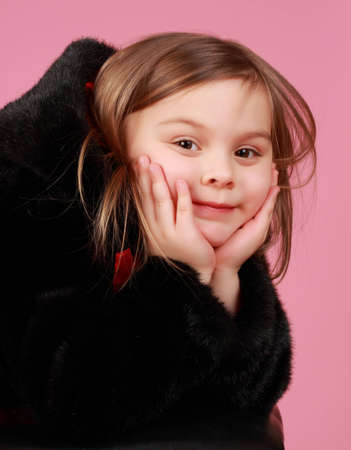 portrait of very cute little girl, pink backgroundの写真素材