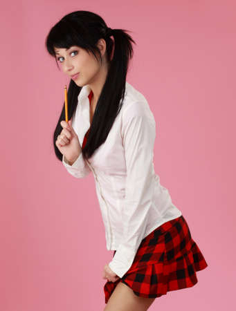 portrait of cute caucasian black haired woman, pink backgroundの写真素材