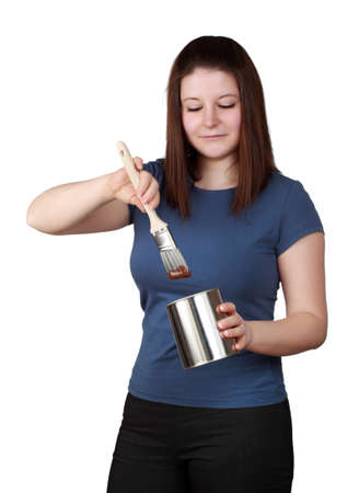 young brunette woman holding brush and paint containerの写真素材