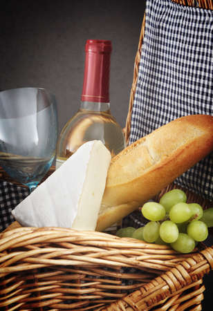 picnic basket with wine, bread and cheese.の写真素材