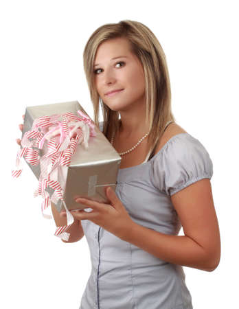 portrait of a beautiful young caucasian blond woman holding a wrapped gift isolated on white backgroundの写真素材