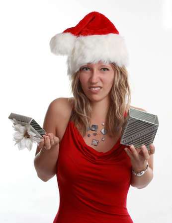 beautiful young woman holding a silver Christmas gift, isolated on whiteの写真素材