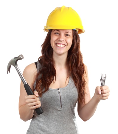 laborer girl holding some nails and hammer, isolated on whiteの写真素材