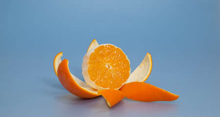 Peeled orange on blue backgroundの写真素材
