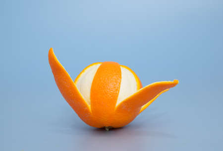 Peeled orange on blue backgroundの写真素材
