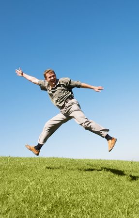happy jumping businessman on the hill