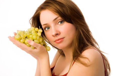 beautiful woman with grapes isolated against white backgroundの写真素材
