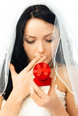 surprised young beautiful bride looking at the wedding ringsの写真素材