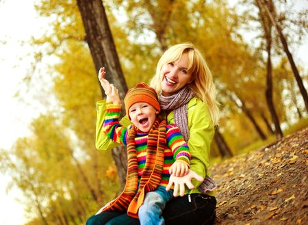 happy young beautiful mother with her little son in the park の写真素材