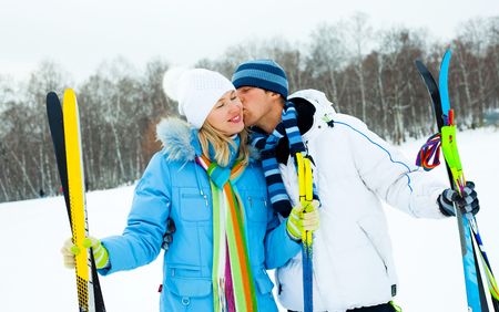 happy young couple going skiing on a warm winter dayの写真素材