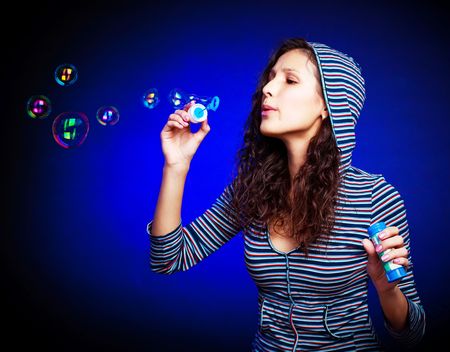 pretty young happy brunette woman with soap bubbles