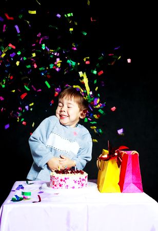 cute three year old baby celebrating his birthday and blowing off the candles on the cakeの写真素材