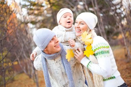 happy young family spending time outdoor in the park (focus on the father)