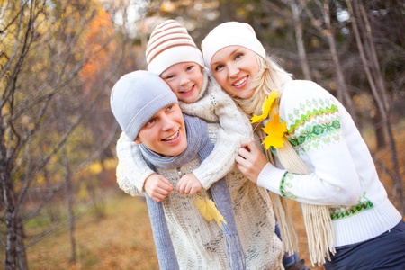 happy young family spending time outdoor in the park (focus on the father)の写真素材