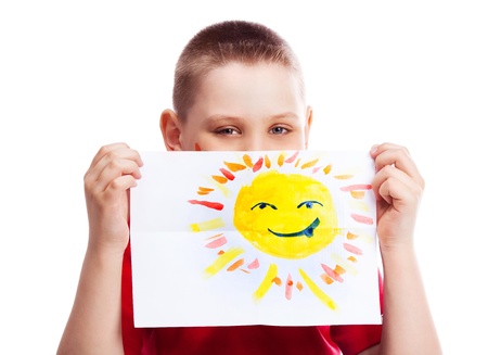 cute ten year old boy with a watercolor picture of the sunの写真素材