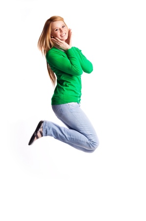 happy jumping teenage girl, isolated against white backgroundの写真素材