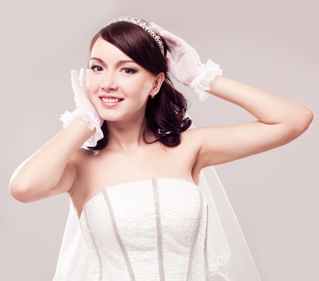 beautiful happy bride, isolated against grey studio backgroundの写真素材