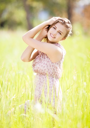 beautiful happy young woman  in the park  on a warm summer dayの写真素材