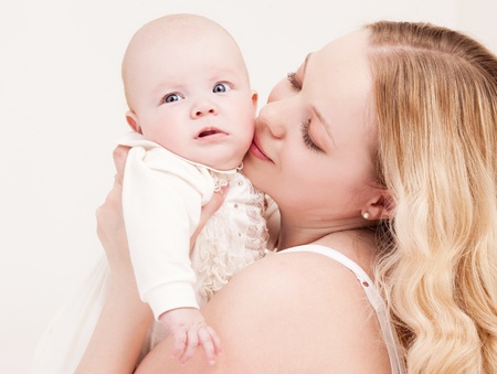 happy young mother and her four months old daughter  at home の写真素材