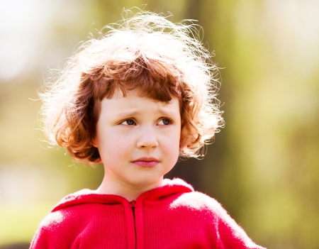 upset five year old girl in the summer parkの写真素材