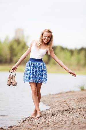 happy young blond woman outdoor on a summer dayの写真素材