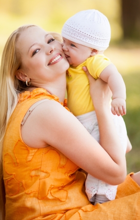 young mother and baby outdoor on a warm summer dayの写真素材