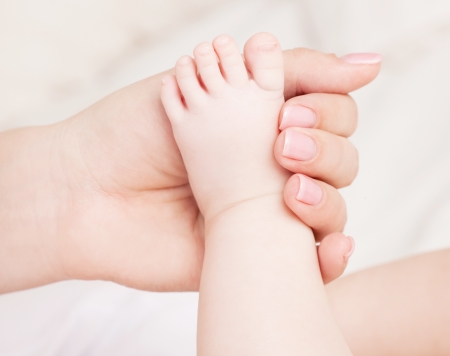 hands of a mother massaging her babyの写真素材