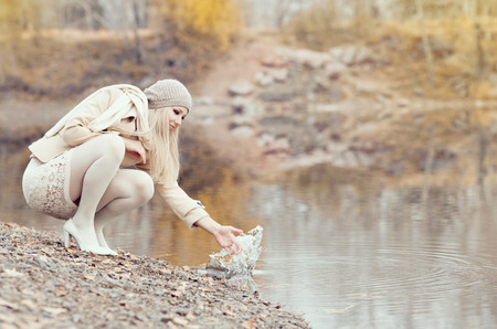 beautiful blond woman outdoor in the autumn parkの写真素材
