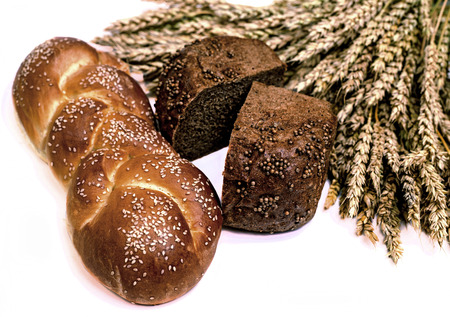 fresh bread and ears of wheat, isolated against white background